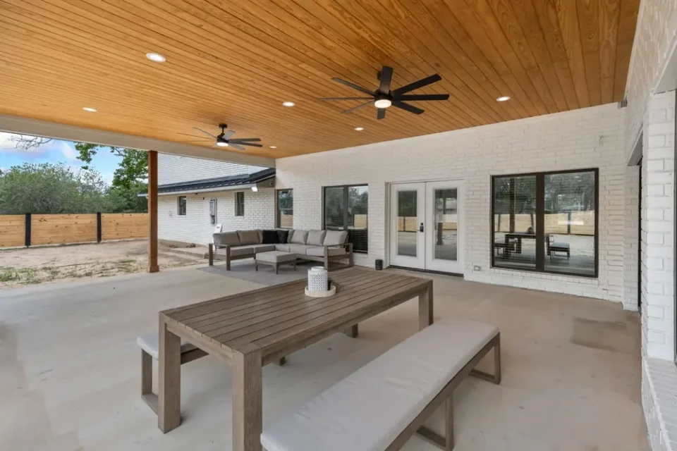 a patio with a table and chairs