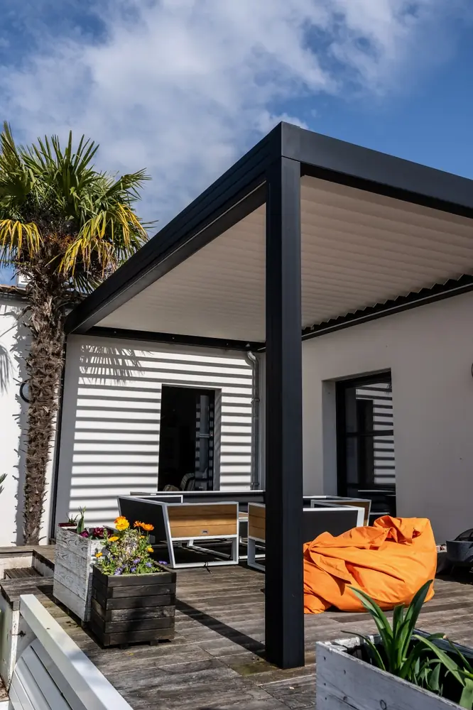 a white house with a black metal structure